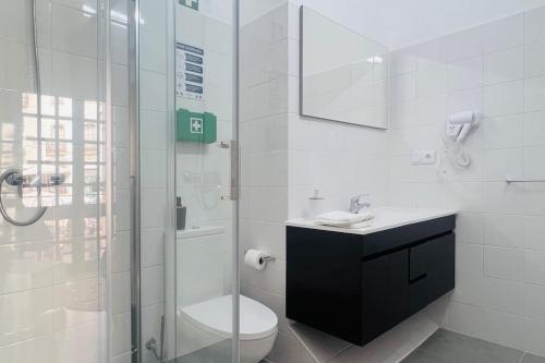 a bathroom with a shower and a toilet and a sink at Palacete da Serenata @ Sé Velha in Coimbra