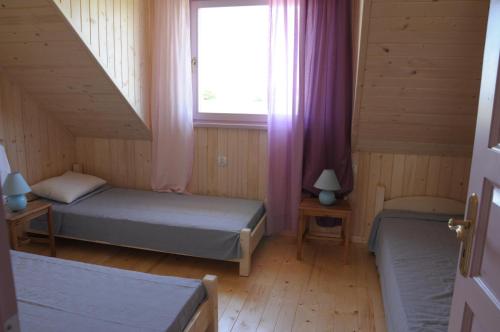 מיטה או מיטות בחדר ב-Lawendowa Wyspa Klub Nadmorski