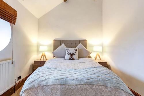 a bedroom with a bed with a stuffed animal on it at The Saddlery Cheshire in Congleton