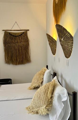 a bedroom with a bed with two pillows on it at HOKKUM STUDIOS in Kokkari