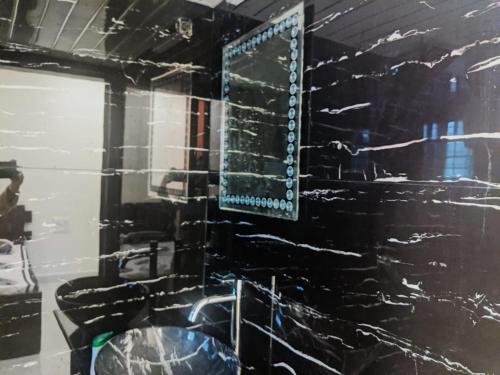 a bathroom with a mirror and a sink at Ivy Little Door Cottage, Compact AC 3 BHK with Pool, Lonavala in Lonavala