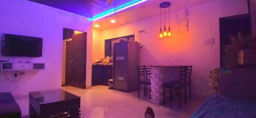 a living room with purple lights in a room at Ivy Little Door Cottage, Compact AC 3 BHK with Pool, Lonavala in Lonavala