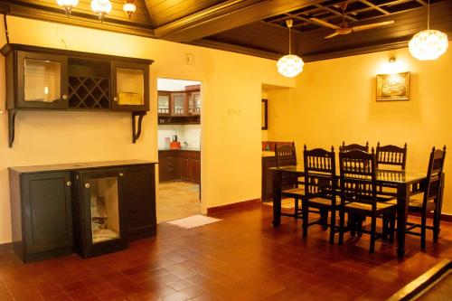 a kitchen and dining room with a table and chairs at Fortbeach Service Apartments in Cochin