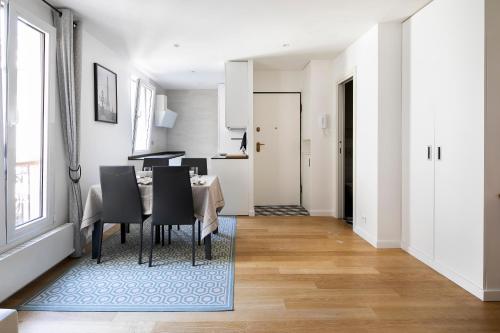 une salle à manger et une cuisine avec une table et des chaises dans l'établissement Beaux 2-pièces Gare du Nord/Gare de l'Est, à Paris