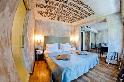 a bedroom with two beds and a chandelier at Boutique Hotel Astoria in Kotor
