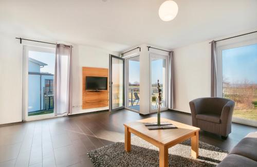 a living room with a couch and a table at Haus Calmsailing in Börgerende-Rethwisch