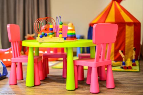 a table and chairs with a play set and a play tent at Hotel Biathlon Sport & Spa in Szklarska Poręba