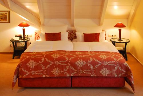 a bedroom with a large bed with two tables at Im Winkel Appartements und Zimmer in Langenargen