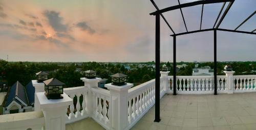a balcony with a white railing and a view of the city at Hotel Phước Thịnh in Vĩnh Long