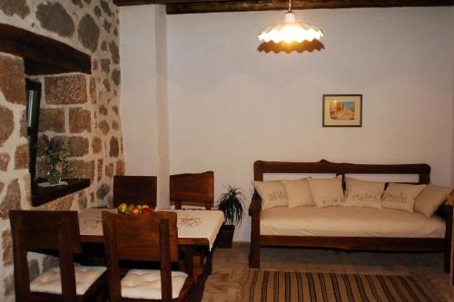 a living room with a bed and a table and chairs at House Marin in Starigrad