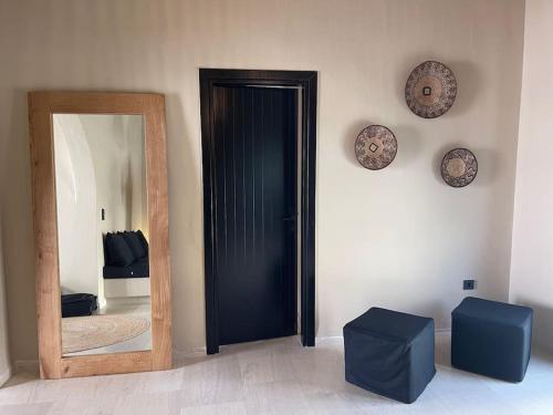 a mirror and a black door in a room at Traditional Cosy Home in Ios Chora