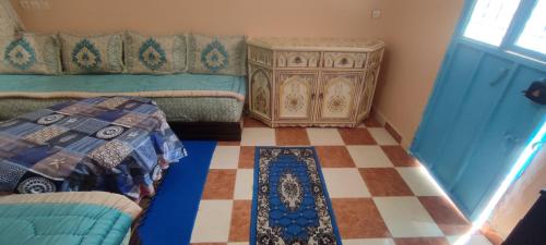 a bedroom with a bed and a dresser and a floor at Mehdi House in Chefchaouen