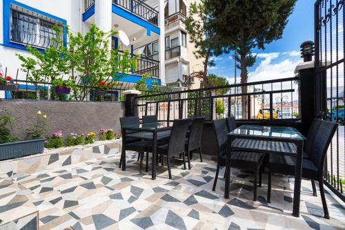 a patio with a table and chairs on a tile floor at 8 Rooms House in Balcova
