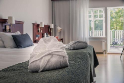 a hotel room with two beds with white towels at Best Western Solhem Hotel in Visby