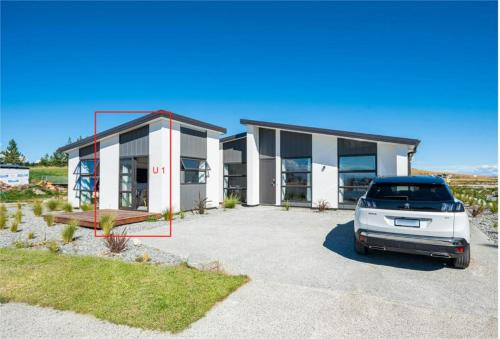 a car parked in front of a house at Tekapo Top 1000 Apartment in Lake Tekapo