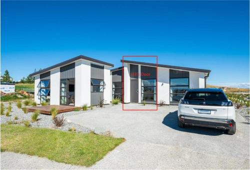 a car parked in a parking lot in front of a building at Tekapo Top 1000 Apartment in Lake Tekapo