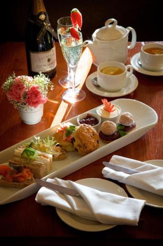 a table with a plate of food and a bottle of wine at Stourport Manor Hotel in Stourport