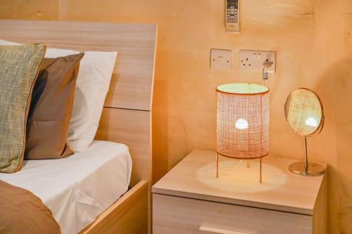 a bedroom with a bed and a lamp on a table at Sliema Unique 4 Bedroom Townhouse Off The Beach in Sliema