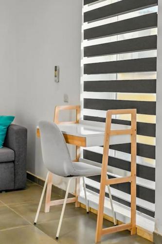 a white chair sitting next to a wall at Sliema Unique 4 Bedroom Townhouse Off The Beach in Sliema