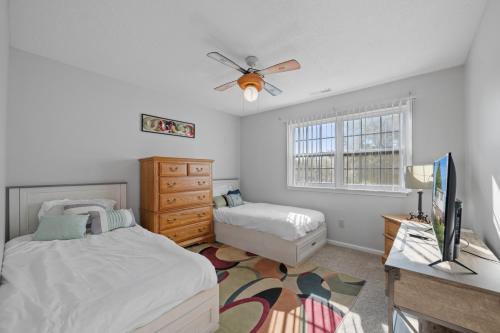 a bedroom with two beds and a ceiling fan at Perfect Private Getaway Minutes to Virginia Beach! in Virginia Beach