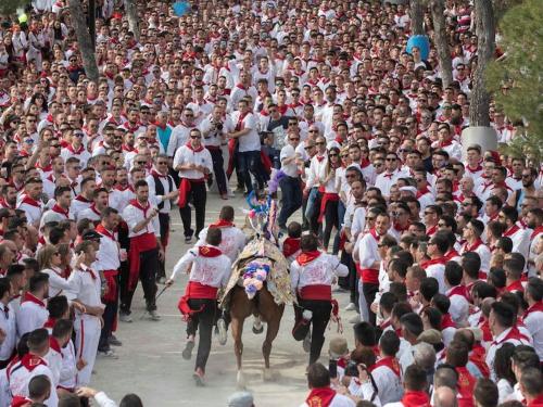 a large crowd of people running in a parade at Alojamiento Central Caravaca in Caravaca de la Cruz