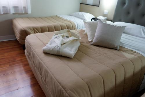 a couch with two pillows and a bag on it at Hotel Sant'Elia in Messina