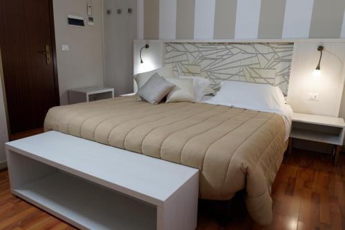 a bedroom with a large bed and two night stands at Hotel Sant'Elia in Messina
