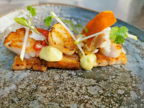 a blue plate with a piece of food on top at Tyn Rhos Country House in Caernarfon