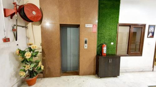 a door in a building with flowers on the wall at Hotel sallow International-Hotel Near Golden Temple in Amritsar