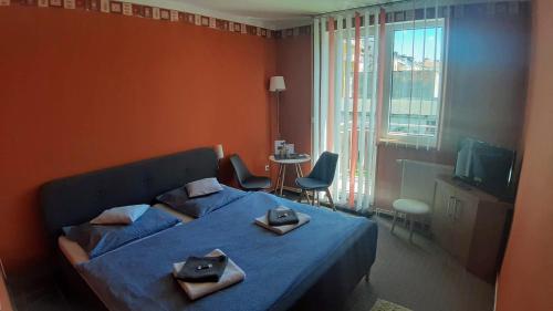 a bedroom with a bed with two pillows on it at Pension Three in Františkovy Lázně