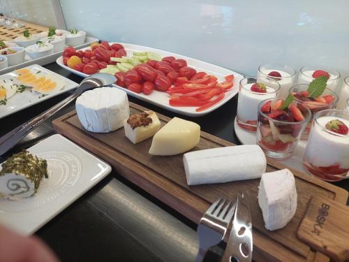 a table with cheese and other foods on it at Pension Three in Františkovy Lázně