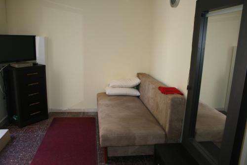a living room with a couch and a television at Guest house Ashdod-beach in Ashdod