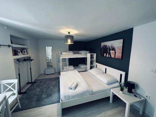 a bedroom with a white bed and an elephant on the wall at Hostel Sleeping Beauty in Ljubljana