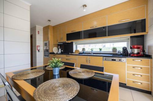 a kitchen with a table and two stools in it at Casa da Tia Douro in Peso da Régua
