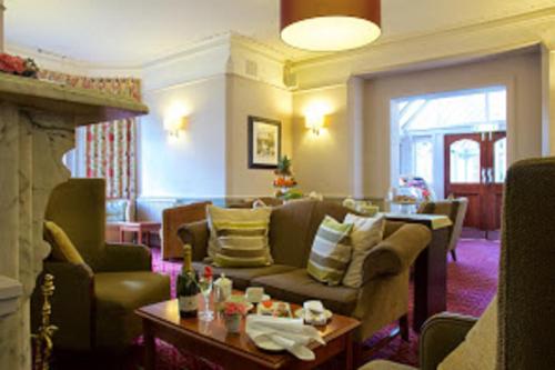 a living room with a couch and a table at Stourport Manor Hotel in Stourport