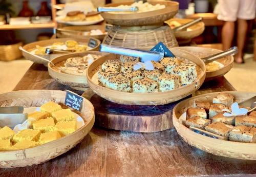 a table with many different types of pastries and cakes at Aldeia do Mar Sensorial Hotel in Itacaré