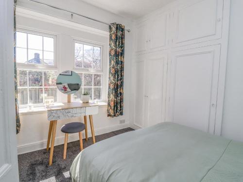 a bedroom with a bed and a desk and a window at 4 Pulmans Place in Halifax