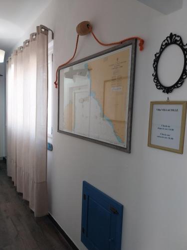 a picture of a map on a wall with a mirror at VILLA VILLACOLLE in Procchio