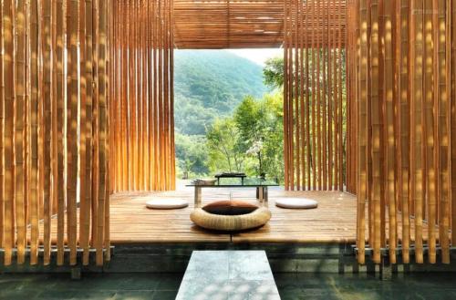 a room with a bench and a table and a window at Commune by the Great Wall, in the Unbound Collection by Hyatt in Yanqing