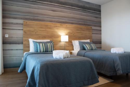 En eller flere senge i et værelse på Caminho Real S - By SCH