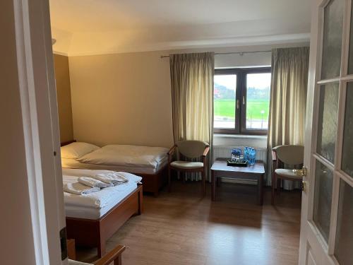 Ένα ή περισσότερα κρεβάτια σε δωμάτιο στο Villa Dudziak