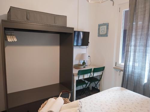 a bedroom with a fireplace with a table and chairs at VILLA VILLACOLLE in Procchio