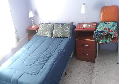 Ένα ή περισσότερα κρεβάτια σε δωμάτιο στο Hospedaje el Abuelo