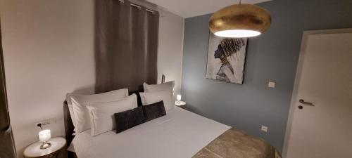 a bedroom with a bed with white sheets and a lamp at Bol Summer Residence in Bol