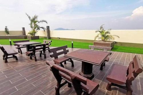 a group of picnic tables and benches on a patio at 92D’venus Residence in Sitiawan