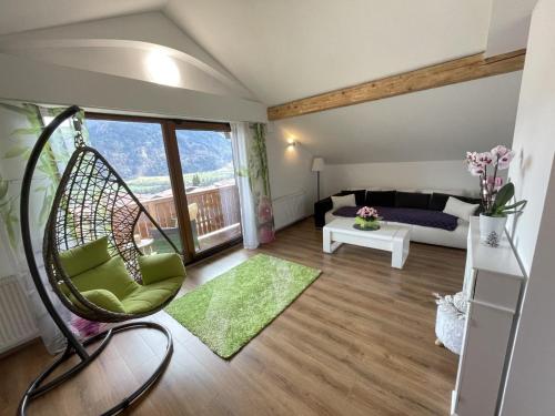 a room with a swing chair and a bed at Panorama in Wiesing