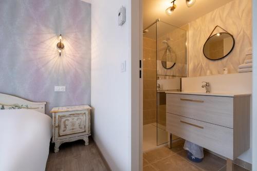 a bathroom with a sink and a mirror at Eqynox Hotel in Vitry-le-François