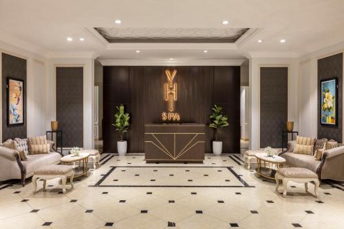 a lobby with couches and a podium with a cross on the wall at Meliá Vinpearl Phu Ly in Phủ Lý
