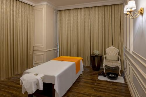 a hotel room with a bed and a chair at Meliá Vinpearl Phu Ly in Phủ Lý