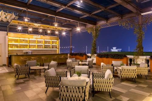 a restaurant with chairs and tables on a patio at night at Meliá Vinpearl Phu Ly in Phủ Lý